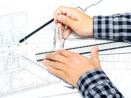 A set of hands drawing and measuring on plansの写真素材