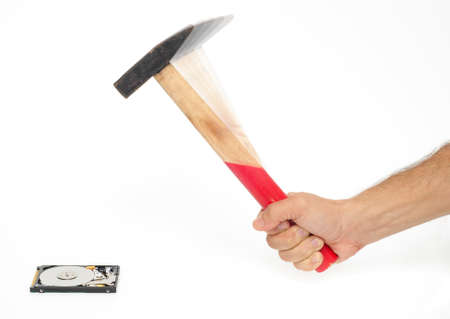 A hammer smashing a hard diskの写真素材