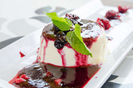 Panna cotta dessert with raspberry jam blueberries raspberriesの写真素材