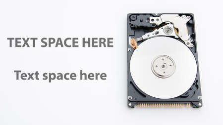 Open hard disk drive on white isolated background with text space next to itの写真素材