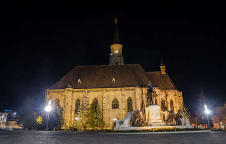 Gothic Cathedral church in the center of Cluj-Napoca in Transylvania Region of Romania with the Unirii Square and Matei Corvin statue during the nightの写真素材