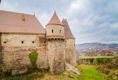 Tower and fortified wall at the Corvinilor Castle in Hunedoara Transylvania Region of Romania also...