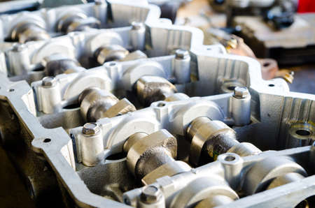 Open engine block exposing the pistons and interior parts with bright sunny light in a workshopの写真素材