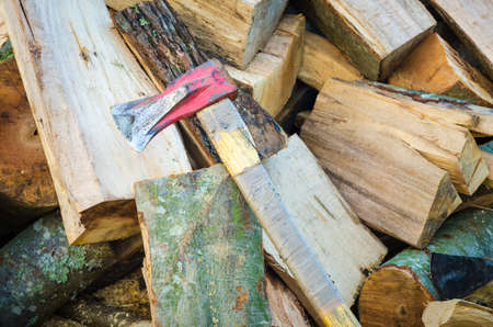 Chopped fire wood and a red axeの写真素材