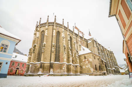 Gothic Lutheran Black Church in Brassov Transylvania Region of Romania on a cold winter day with white snow built in the 15 th centuryの写真素材