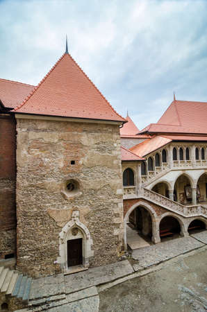 HUNEDOARA, ROMANIA - MARCH 15: Interior courtyard view of the neogothic Corvinilor Castle in Hunedoara region of Romania with a cloudy sky with a towerのeditorial素材
