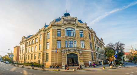CLUJ-NAPOCA, ROMANIA - 11 NOVEMBER 2014: Universitarian Library in Lucian Blaga - Pacii - square on a sunny autumn day with students in front and no traffic with an old imposing look considered one of the main monuments in the cityのeditorial素材