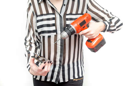 A woman recovering sensitive data software and files from a hard drive with a electric screwdriverの写真素材