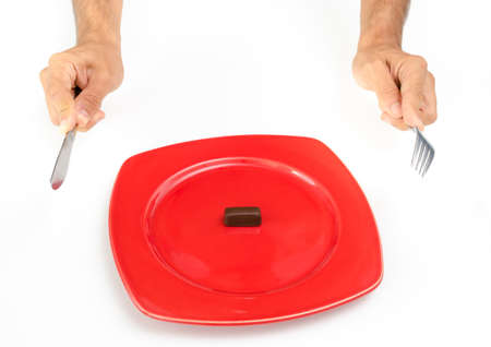 Small chocolate on a red plateの写真素材
