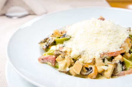 Traditional italian tagliatelle with ham mushrooms and parmesan cheeseの写真素材