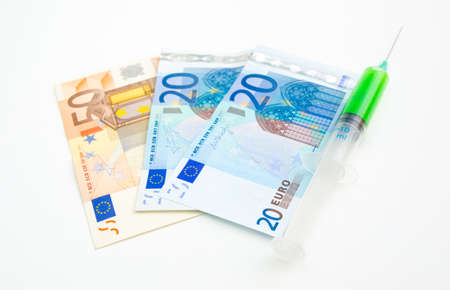 Toxic chemicals in a syringe over euro billの写真素材