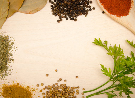 HErbs and spices on wood suited for a menu background