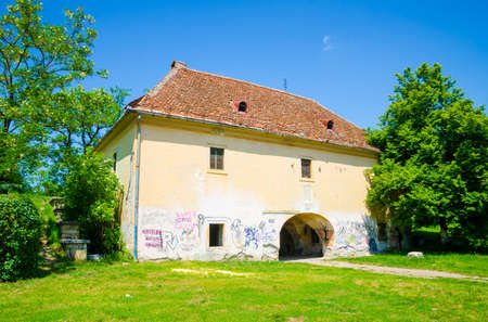 Old abandoned and vandalized with grafitti medieval baroque building that once was a gatehouseの写真素材