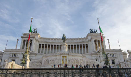 ROME, ITALY - 1 December 2015: Mausoleum of Emmanuel  Vittorio Due II dedicated to the heroes of Italy on a bright warm sunset with a blue sky and people walking around anbd enjoying the monumentのeditorial素材