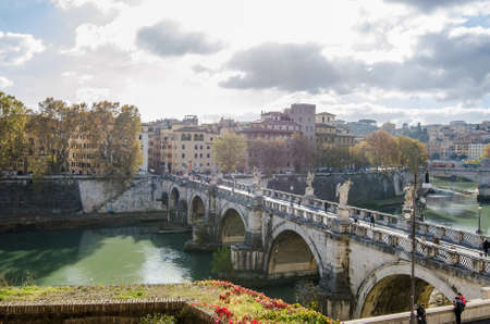 ROME, ITALY - 1 December 2015: Ponte Aelius bridge over the Tiber River with the old city and a sunny blue cloudy skyのeditorial素材