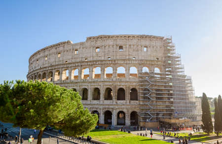 ROME, ITALY - 29 November 2015: Colosseum exterior with the scaffolding for restauration works and people walking near by this wonderful ancient monumentのeditorial素材
