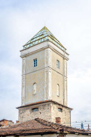 Fireman's tower in the medieval historic center of Cluj Napoca city in Transylvania region of Romania. A mixture of medieval, baroque and modern architecture with the pyramid on top, used in older times for fire watch purposesの写真素材