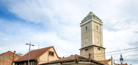 View of the old fireman's tower, one of the few remaining towers from the old Cluj Napoca medieval defence walls, extended and used in more recent times as a watchtower. A mixture of medieval, baroque and modern architectureの写真素材