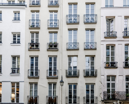 Historic facades with french balconies or balconettes on old classic parisian buildingsの写真素材