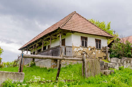 Traditional abandoned transylvanian adobe house in a rural area with a sad degrading lookの写真素材