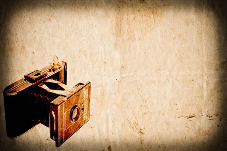 Antique camera on vintage paper backgroundの写真素材