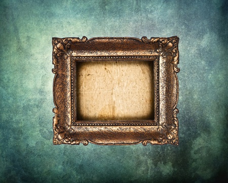 Empty golden frame on grunge light blue wallの写真素材