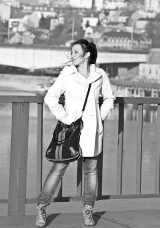 Brunette woman posing at empty bridge in black and whiteの写真素材