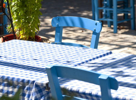 Detail of traditional Greek tavern blue tables and chairsの写真素材