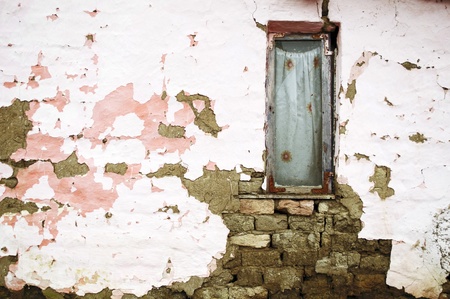 Broken window on the abandoned house wallの写真素材