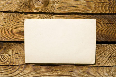 Grunge note paper on wooden background の写真素材