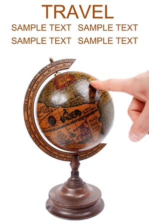 Hand pointing to antique globe - Travel conceptの写真素材
