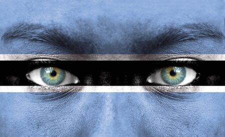 Human face painted with flag of Botswanaの写真素材
