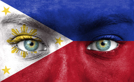 Human face painted with flag of Philippinesの写真素材