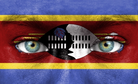 Human face painted with flag of Swazilandの写真素材