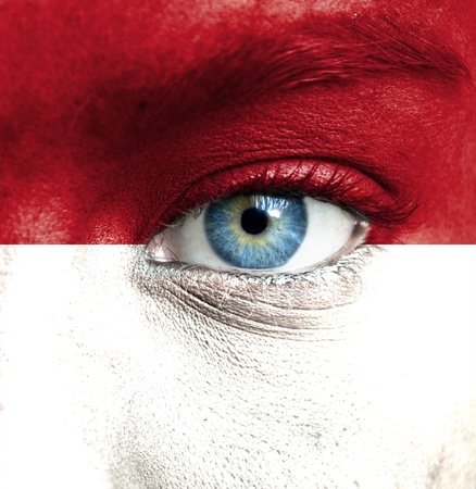 Human face painted with flag of Indonesiaの写真素材