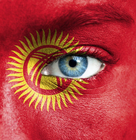 Human face painted with flag of Kyrgyzstanの写真素材