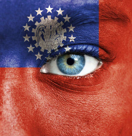 Human face painted with flag of Myanmarの写真素材