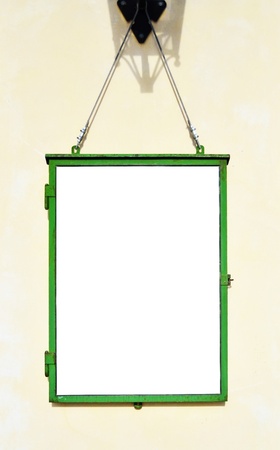 Blank note board hanging on wallの写真素材