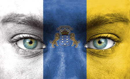 Human face painted with flag of Canary Islandsの写真素材
