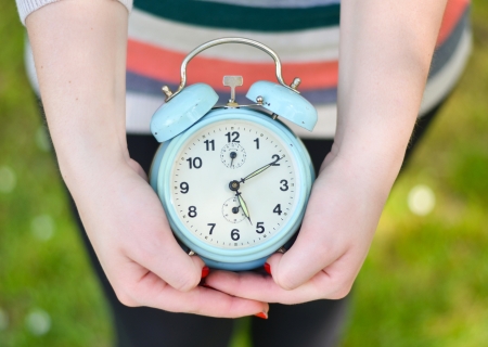 Hands holding old clockの写真素材