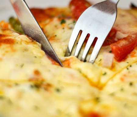 Cutting pizza macro shotの写真素材