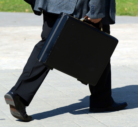 Businessman walking with bag - "Business on the run" conceptの写真素材