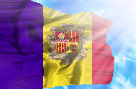 Andorra waving flag against blue sky with sunraysの写真素材