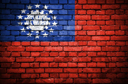 Brick wall with painted flag of Myanmarの写真素材