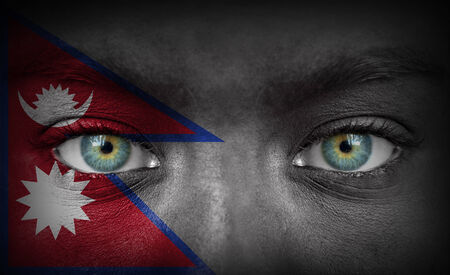 Human face painted with flag of Nepalの写真素材