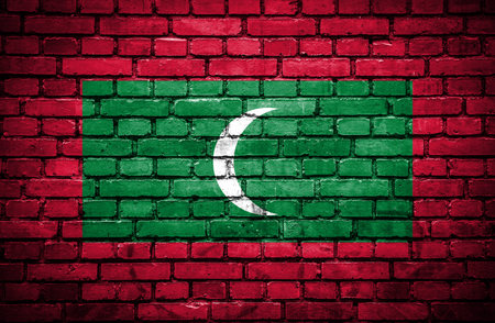 Brick wall with painted flag of Maldivesの写真素材