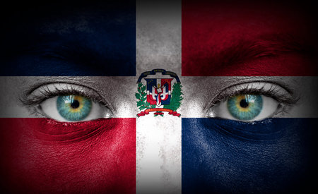 Human face painted with flag of Dominican Republicの写真素材