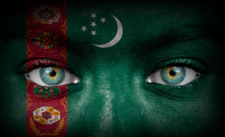 Human face painted with flag of Turkmenistanの写真素材