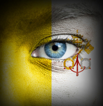 Human face painted with flag of Vaticanの写真素材