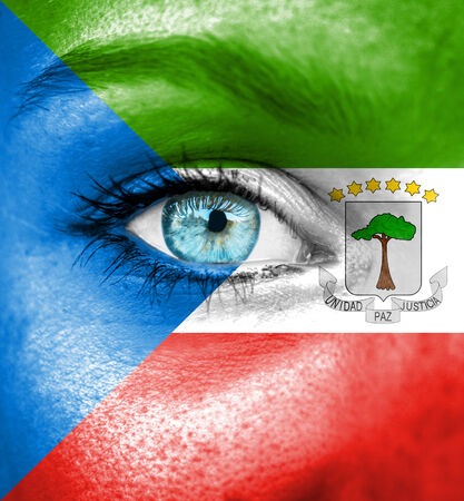 Woman face painted with flag of Equatorial Guineaの写真素材